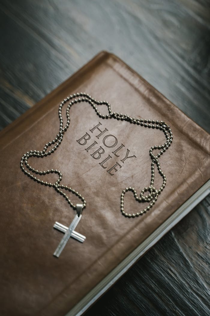 about-05 Close-up image of a Holy Bible with a cross necklace, emphasizing Christian faith.